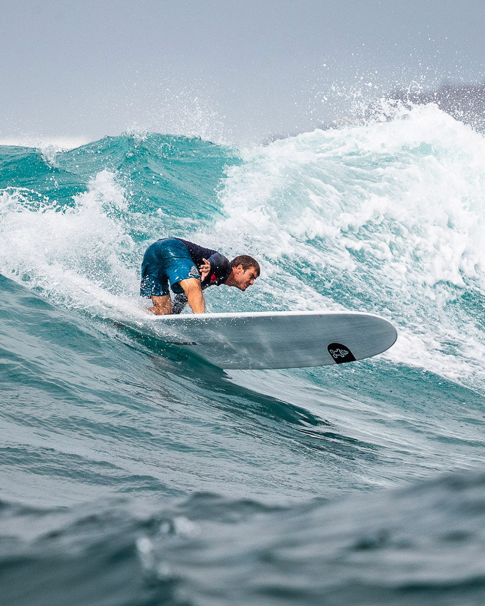 White Longboard Surf with Black Logo and Blue Leash
